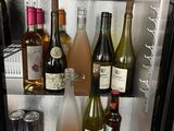 many bottles of wine on the shelves in the refrigerator