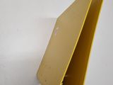 a yellow wallet sitting on top of a table next to a white table