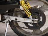 a close up of a motorcycle with a chain attached to it