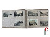 an open book with a picture of a mountain scene on it