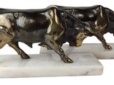statue of a bull on a marble base on a white background