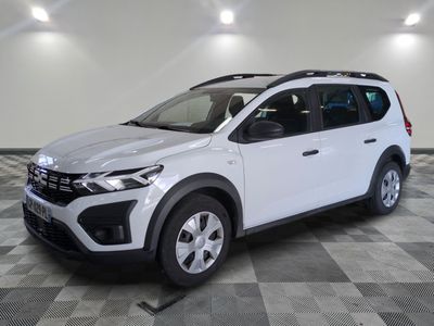 the white car is parked in a large room with a checkered floor