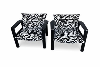 pair of black and white zebra print chairs with black legs