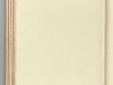 an open book sitting on top of a table next to a white wall