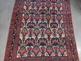an antique persian rug with a blue and red design