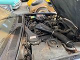 a car engine with the hood open on the street