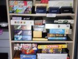 a bookcase filled with lots of different types of games
