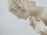 marble statue of a woman kneeling down with her hands on her knees