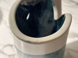 a close up of a cup with a cat inside of it