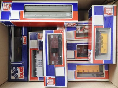 several boxes of toy trains are stacked on top of each other