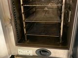 an oven that is open with a lot of food inside of it
