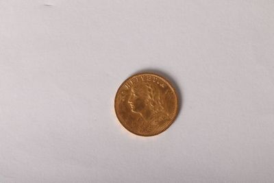 a small coin that is on a white surface
