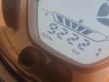 a close up of a clock on the side of a table