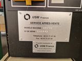 a machine that has a sign on it that says usm france service aprres - vente