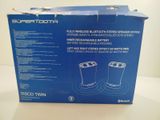 the box of the bluetooth speaker is open on the table