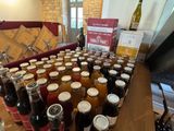 many jars of food and drinks sitting on a table