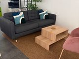 a living room with a couch, chair, coffee table, and television