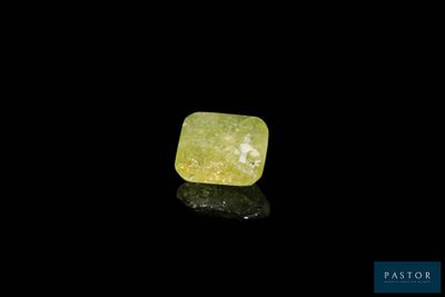 a yellow diamond on a black surface