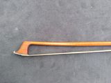 an image of a wooden and metal tool on a gray surface