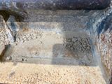 a rusted metal box with a hole in it
