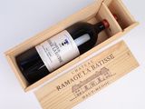 a wooden box with a bottle of wine inside of it