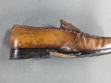 brown leather loafer shoes on display on a gray surface