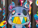 a skateboard that has a picture of a cartoon bear on it
