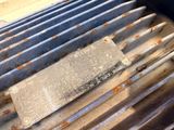 a metal grill with several knives on top of it