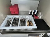 a tray with utensils and spoons sitting on a counter