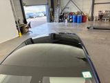 an image of a car in a garage with a sticker on the hood