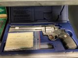 a gun in a blue case on a shelf