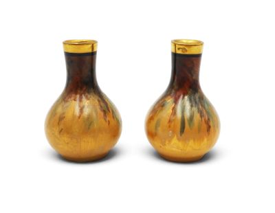 two brown vases sitting next to each other on a white surface