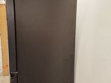 an image of a black refrigerator in a room