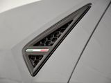 a close up of the emblem on the front of a white sports car