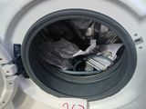 a close up of a washing machine with a lot of items inside of it
