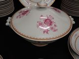 many plates and bowls that have pink flowers on them