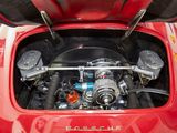 a close up of a red car engine with its hood open