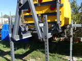 a yellow and black machine that is parked in the grass