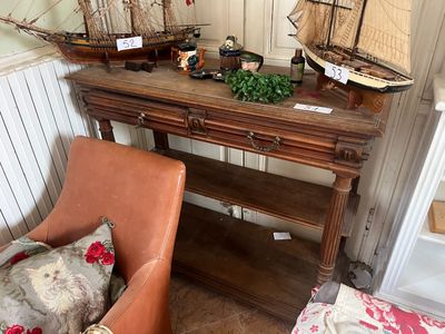 a wooden table with a boat on top of it