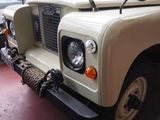 a white land rover parked on the side of the street