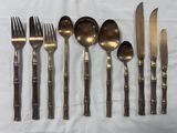 a lot of forks, spoons, and knives on a table