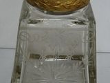 a glass jar with a gold lid sitting on a table