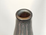 a vase that has a black and white design on it