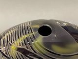 a fish shaped vase with a black and yellow design