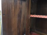 a wooden cabinet with a door open on the floor