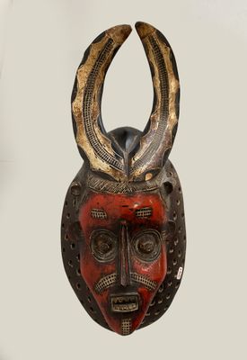 an image of a wooden mask with horns on it ' s head