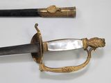 two swords that are laying side by side on a table