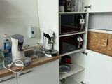 a small kitchen with a microwave and a sink in it