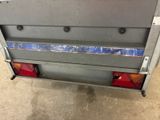 an image of the back end of a truck with the tail lights on