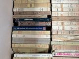 a lot of books stacked on top of each other in a box